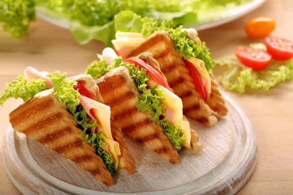 Fresh sandwiches on wooden background — Stock Photo, Image