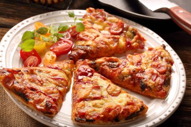 Ev yapımı pizza beyaz bir plaka üzerinde