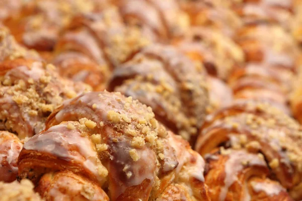 Fresh croissant  with nuts and icing in the cake shop — Stock Photo, Image