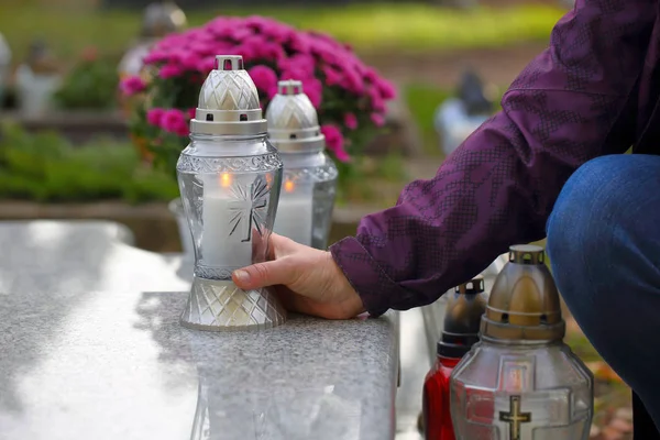 Mujeres en el cementerio ponen una vela en la tumba — Foto de Stock