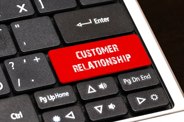 On the laptop keyboard the red button written CUSTOMER RELATIONS — Stock Photo, Image