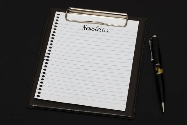 Top view of clipboard and white sheet written with Newsletter on — Stock Photo, Image