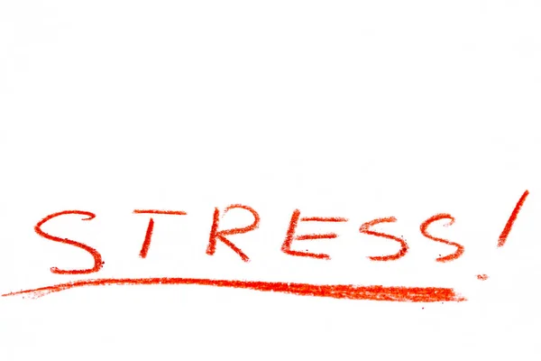 En röd pastell penna skriva ordet stressad. — Stockfoto