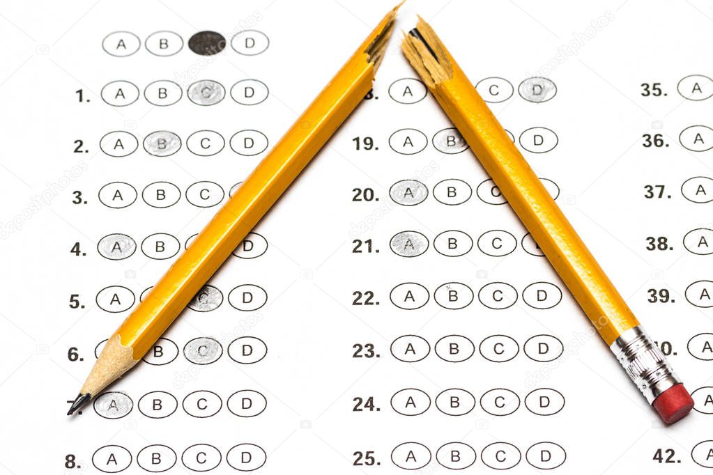 Standardized test form with answers and a broken pencil