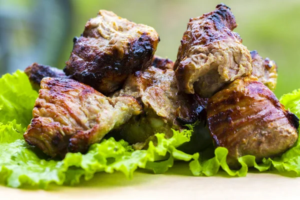 Pork shish kebab on a wooden table — Stock Photo, Image