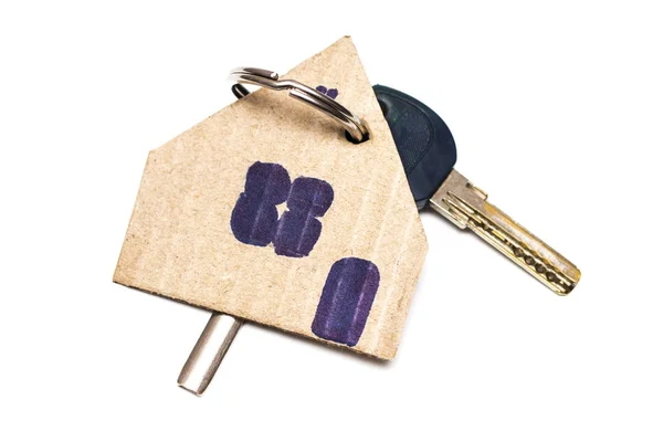 Символ дома с ключом на белом изолированном фоне — стоковое фото