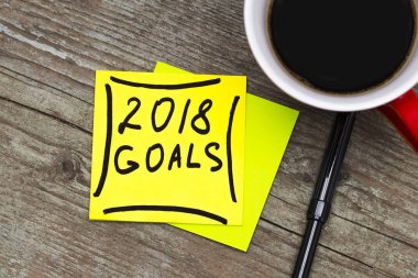 2018 goals - handwriting in black ink on a sticky note with a cu clipart