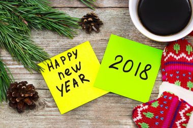 new year 2018 - handwriting in black ink on a sticky note with a clipart