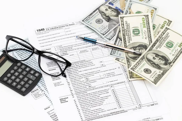 The tax forms with the glasses, money and the pen — Stock Photo, Image