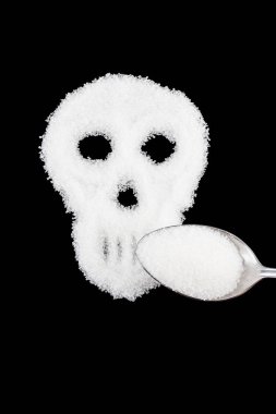The skull made from sugar. Sugar Kills.Black  background. diabet clipart