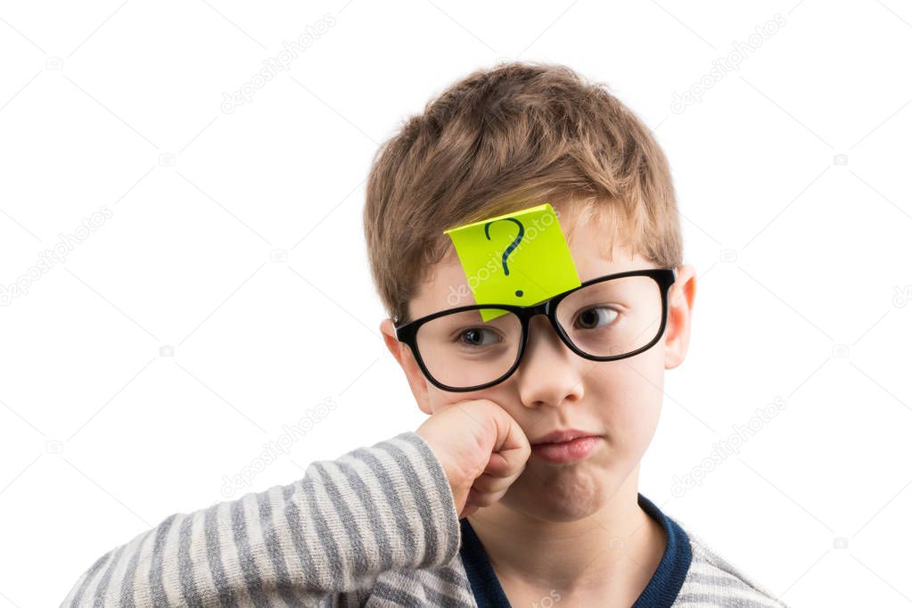 Confused boy thinking with question mark on sticky note on foreh