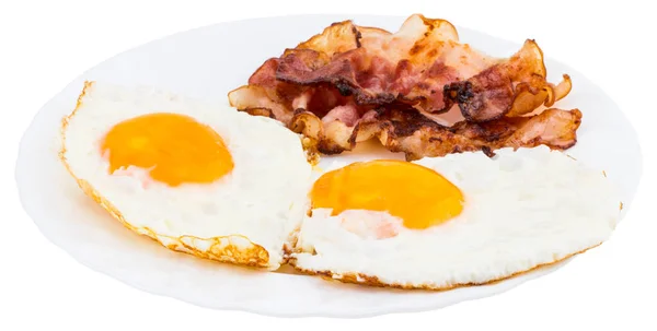 Plate with fried eggs and bacon on white background — Stock Photo, Image