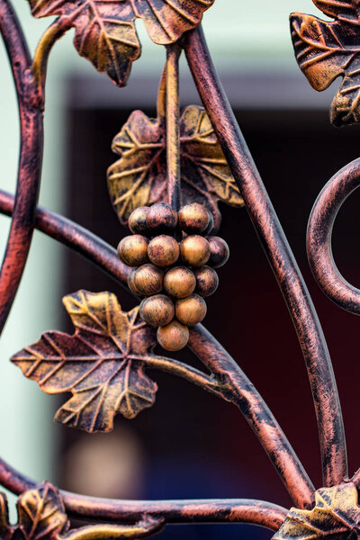 Forged bunch of grapes. ornate wrought-iron elements of metal ga