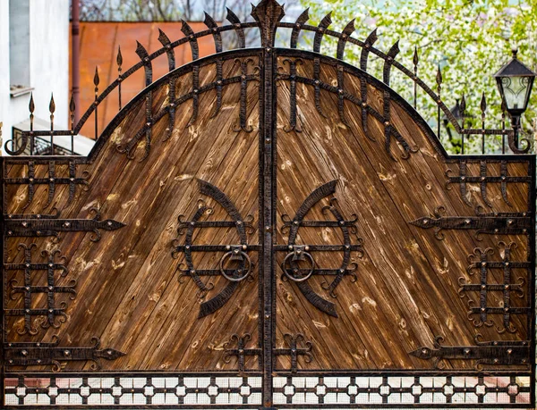 Portão de madeira com elementos de ferro forjado fechar — Fotografia de Stock