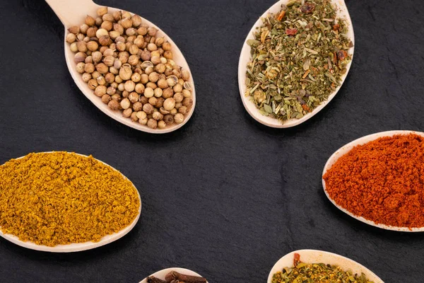 Colourful various herbs and spices on dark background. Top view — ストック写真