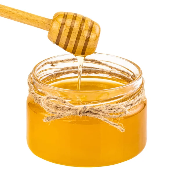 Honey pot and dipper isolated on white background Royalty Free Stock Photos
