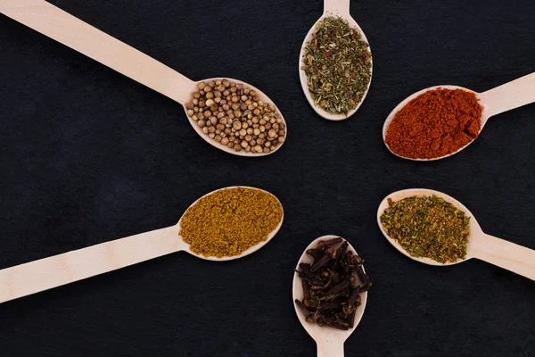 Colourful various herbs and spices on dark background. Top view — ストック写真