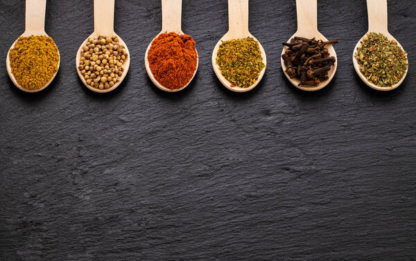 Various spices on dark background. Top view with copy space