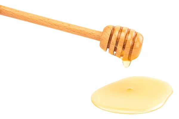 Miel goteando aislada sobre un fondo blanco — Foto de Stock