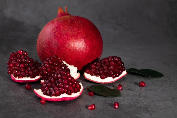 Ripe pomegranate fruits on a dark background — Stock Photo, Image