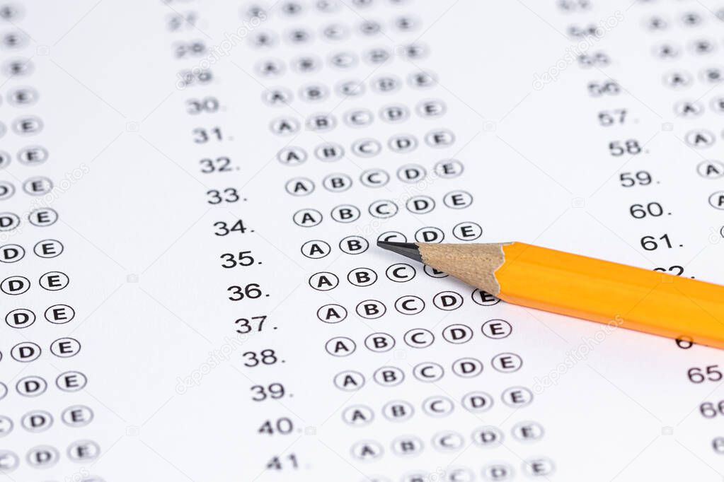 Answer sheet form with pencil on table, close up. Concept of passing exam.