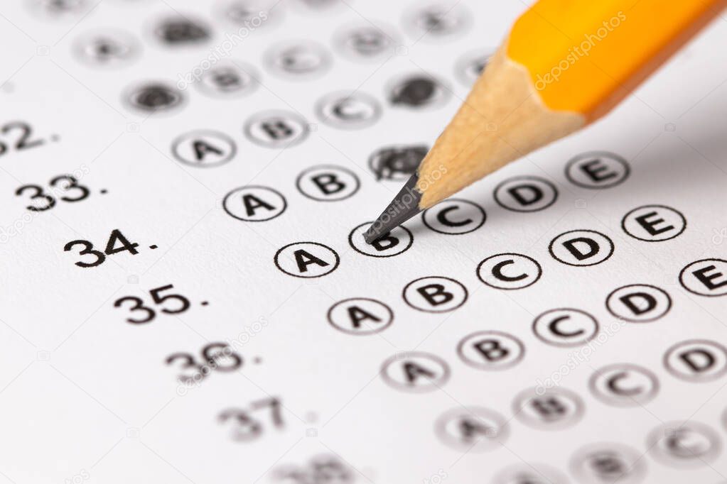 Answer sheet form with pencil on table, close up. Concept of passing exam.