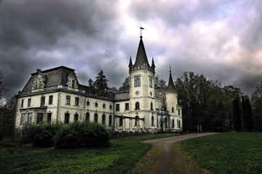 Old mystic palace at night with stormy sky clipart