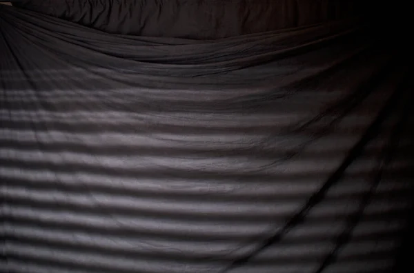 Striped window blind light on black backdrop — 스톡 사진