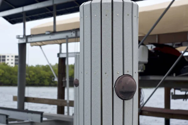 Close up of gray pylon on boat dock with light — Stock Photo, Image