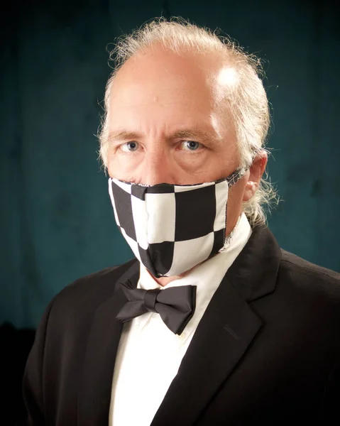 A white american man is in  formal dress suit wearing checkered safety mask during covid-19 virus scare outbreak.