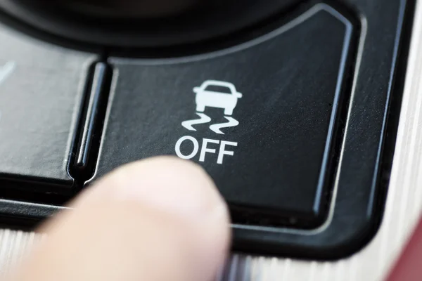 Finger pressing Traction Control System button — Stock Photo, Image