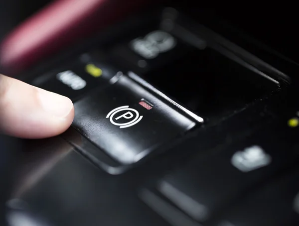 Finger pressing the  Electronic Parking Brake button — Stock Photo, Image