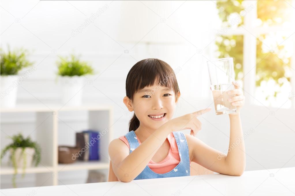 happy Child drinking water from glass