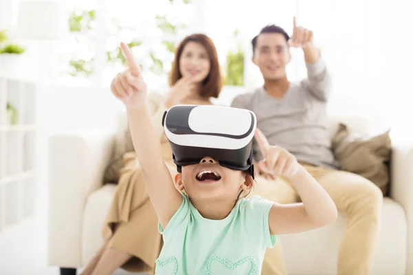 Happy family with virtual reality headset in living room — Stock Photo, Image