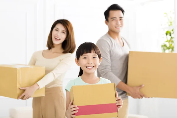 Happy family holding box moving to new home — Stock Photo, Image