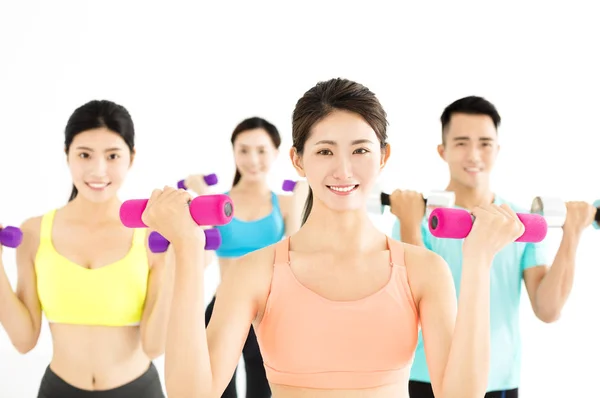 Smiling young fit group stretching in gym — Stock Photo, Image