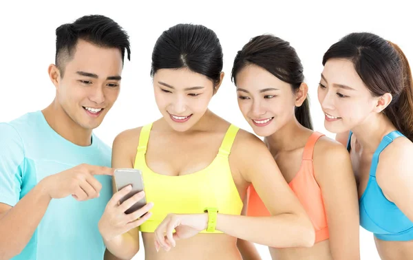 Glad ung passa gruppen titta på smartphone och klocka — Stockfoto