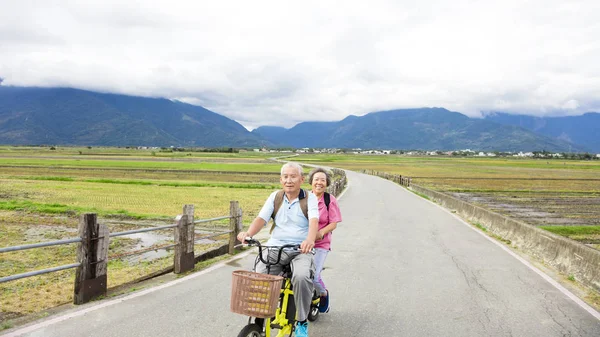 Felice Coppia Senior Equitazione Bicicletta su strada di campagna — Foto Stock