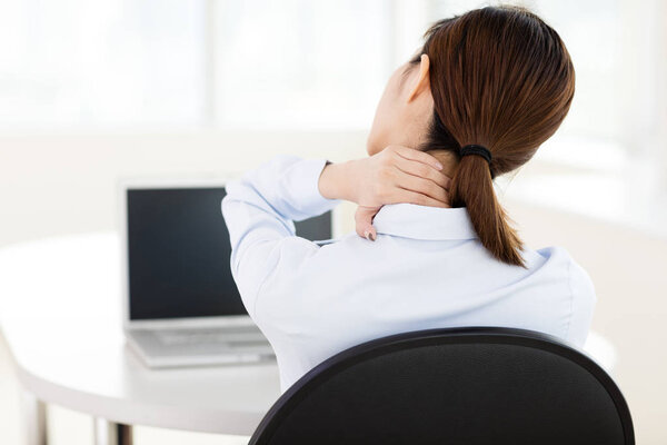 young Business woman with neck ache in office