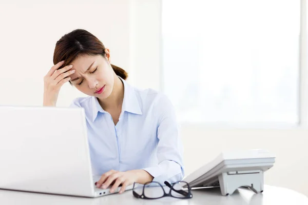 Young businesswoman with tired eyes and headache — Stock Photo, Image