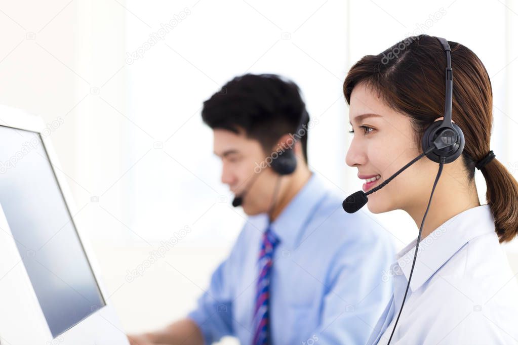 business Woman and man wearing headset in office