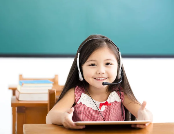 Happy little girl  Using Digital Tablet In Clas — Stock Photo, Image