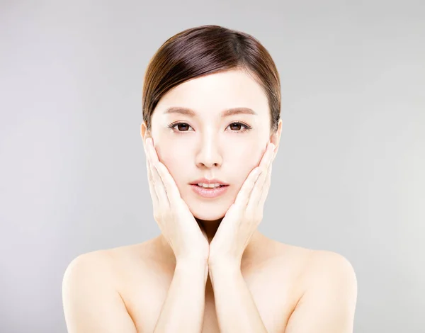 Closeup young  woman face with gray background — Stock Photo, Image