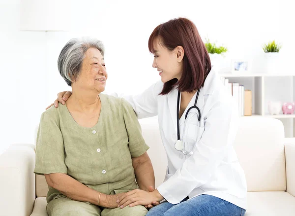 Joven sonriente casa cuidador con senior mujer —  Fotos de Stock