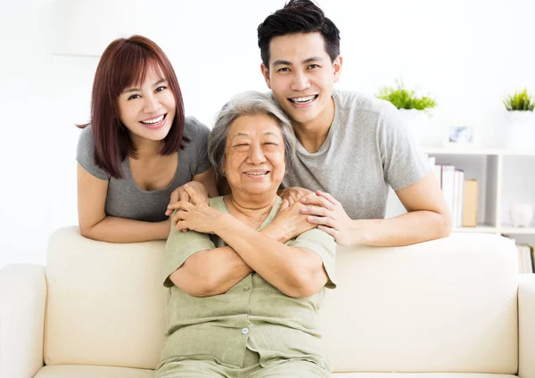 Happy young couple with grandmother — Stock Photo, Image