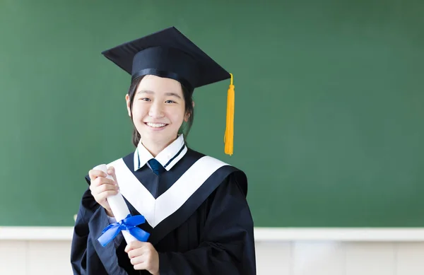 Smiling young graduation student in her classroom — Stock Photo, Image