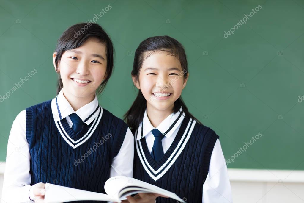 smiling  teenager student girls in  classroom