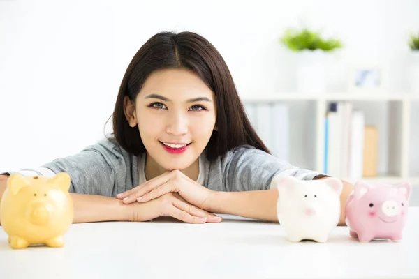 Sorrindo jovem mulher e porquinho banco — Fotografia de Stock