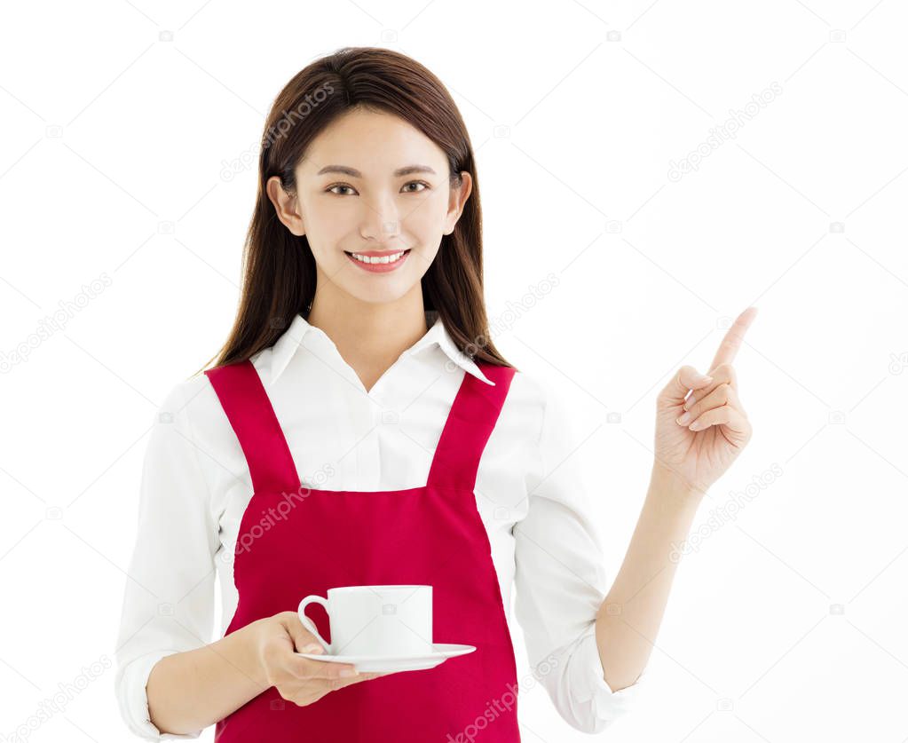Young  woman showing cup of coffee and  pointing gesture