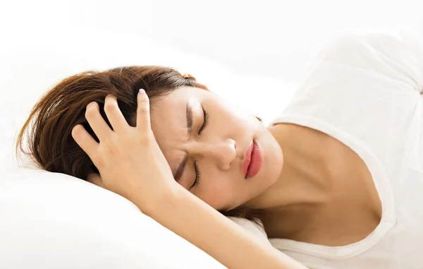 Young Woman with headache in bed — Stock Photo, Image